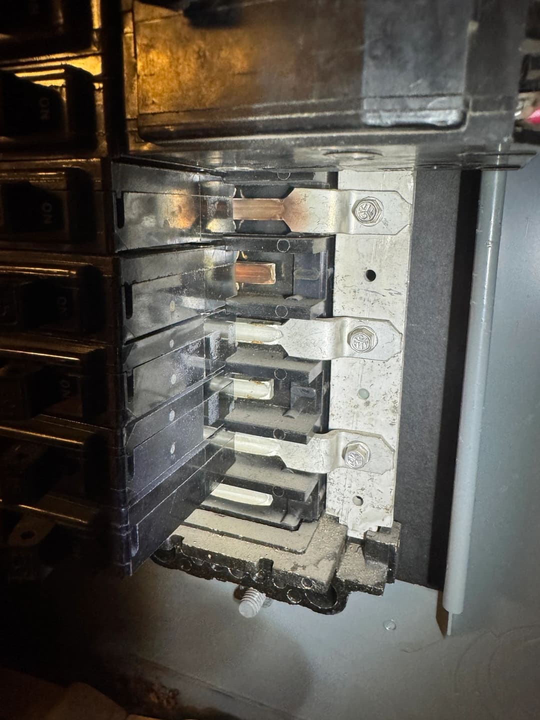 Close-up of a circuit breaker panel with multiple breakers and wiring detail.